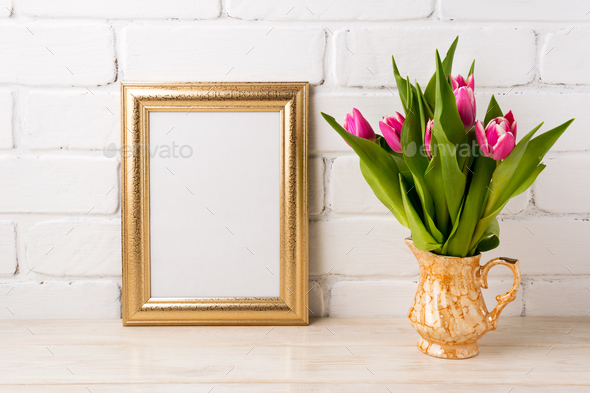 Golden frame mockup with magenta pink tulips in golden vase - Stock Photo - Images