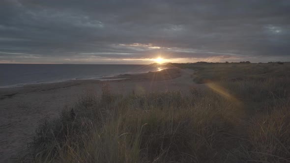 Amazing view of wild beach in scotland during sunrise. Sun above the horaizon causing flairs. wide a alt