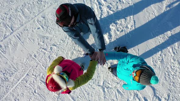 Closeup View From Above of Young People Putting Their Hands Together alt