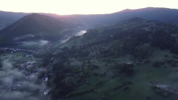Aerial View Inversion in a Valley with Forests Meadows at Sunrise
