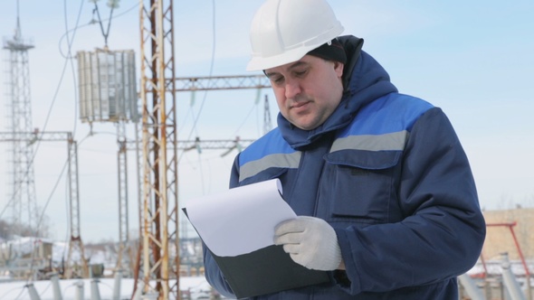 Engineer With Tablet at Electric Power Station