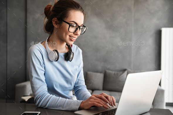 Portrait of an attractive young woman in headphones - Stock Photo - Images