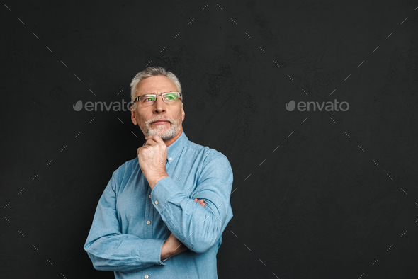 Portrait of elderly man 70s with grey hair and beard touching hi - Stock Photo - Images