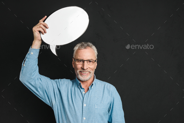 Portrait of a cheerful mature man dressed in shirt Stock Photo by vadymvdrobot