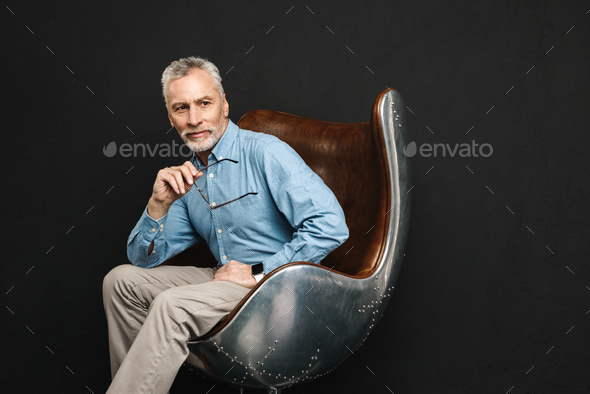 Image of businesslike gentleman 50s with grey hair and beard in - Stock Photo - Images
