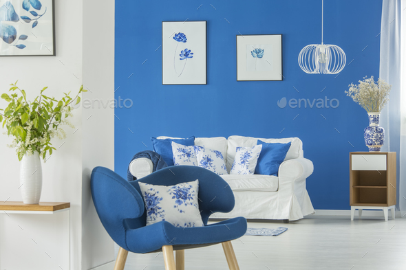 Blue armchair by white wall - Stock Photo - Images