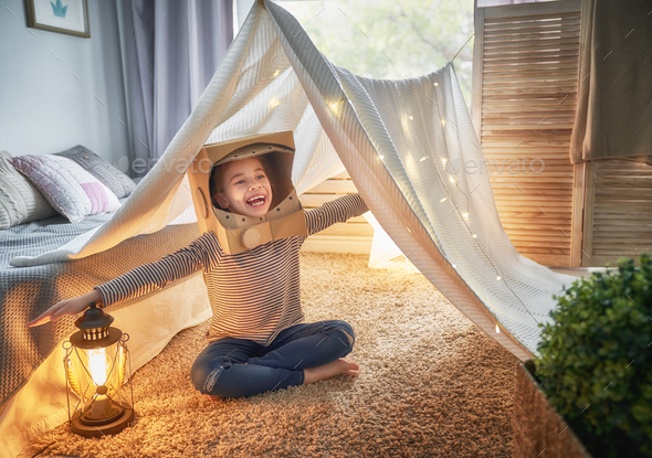kid playing in tent - Stock Photo - Images