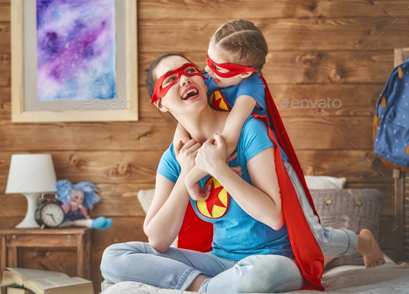 Girl and mom in Superhero costume - Stock Photo - Images