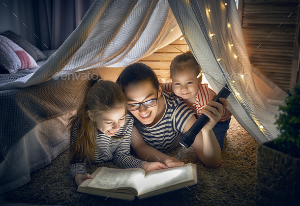 Mom and children reading book - Stock Photo - Images