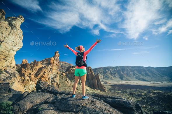 Woman hiker with arms outstretched enjoy mountains - Stock Photo - Images