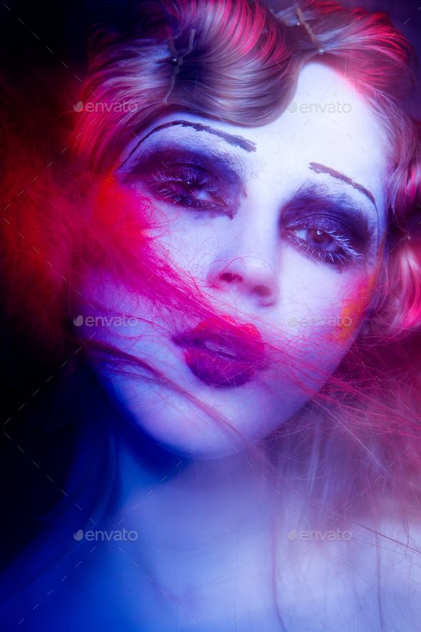 High Fashion model woman in colorful bright lights posing in studio - Stock Photo - Images