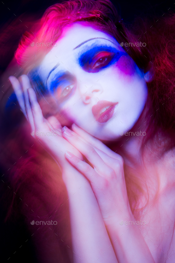 High Fashion model woman in colorful bright lights posing in studio - Stock Photo - Images