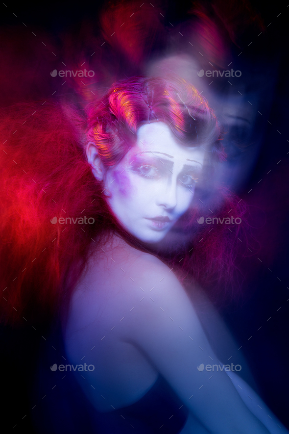 High Fashion model woman in colorful bright lights posing in studio - Stock Photo - Images