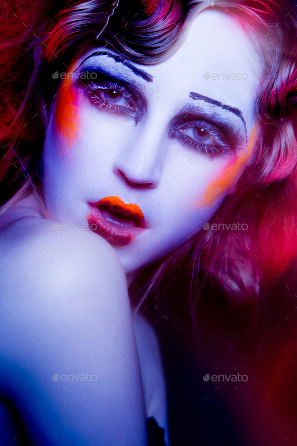 High Fashion model woman in colorful bright lights posing in studio - Stock Photo - Images