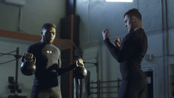 Trainer Supporting Black Man During Lifting Weights, Stock Footage