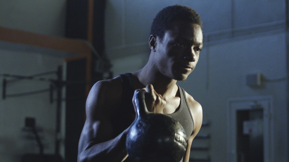 Focused Athlete Training with Heavy Kettlebell alt