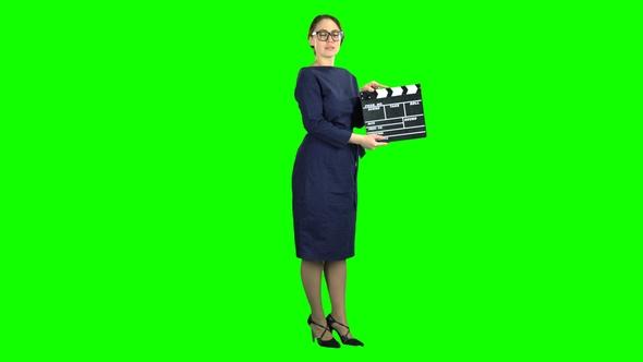 Director with Clapper Board Is Holding a Movie in the Hands and Announcing the Scene alt
