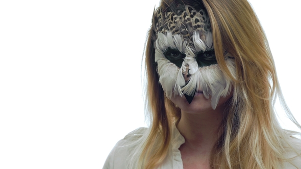  Girl with a Make-up Feather of a Bird Looking in Front of Her Imitating an Owl alt