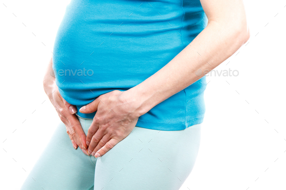 Pregnant woman with hands on her stomach, pregnancy health care and bladder aches - Stock Photo - Images