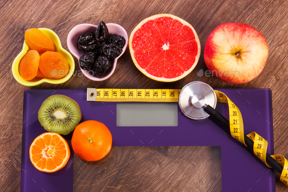 Electronic bathroom scale, centimeter and stethoscope, healthy food and lifestyles concept - Stock Photo - Images
