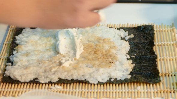 The Cook Makes a Filling for Sushi Roll