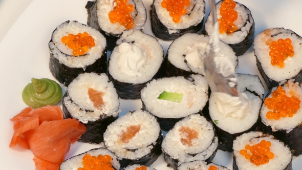 To Decorate Sushi with Red Caviar and Cheese