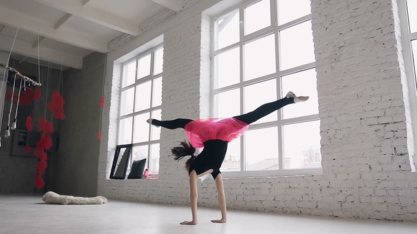 Gymnastics School. Cute Gymnast Girl Performs a Back Flips with Hands in the Spacious White Ballroom alt