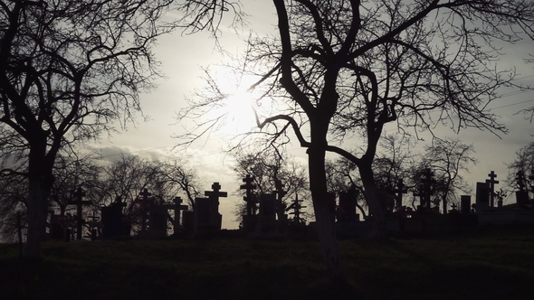 Halloween Background. Old Graveyard with Ancient Crosses at Sunset