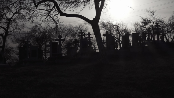 Old Graveyard with Ancient Crosses at Sunset. Scary Cemetery