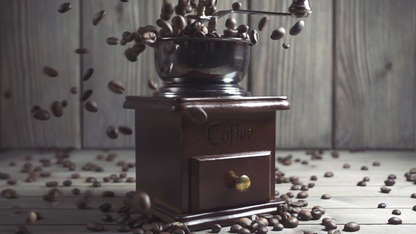 Coffee Beans Fall in the Old Grinder.