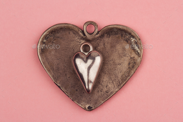 two vintage heart shaped jewels on top of each other