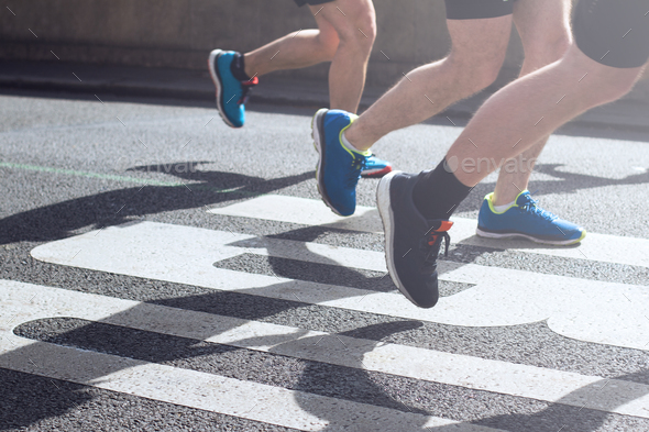 synchronized legs of marathon runners - Stock Photo - Images