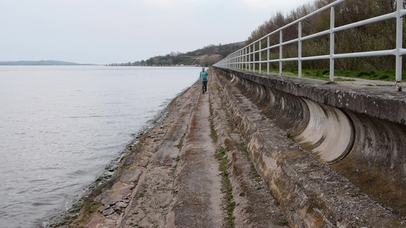Middle Aged Man Running on the Shore of the Lake