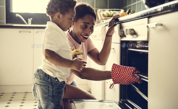 Black kid helping mom baking cookies in the kitchen Stock Photo by Rawpixel