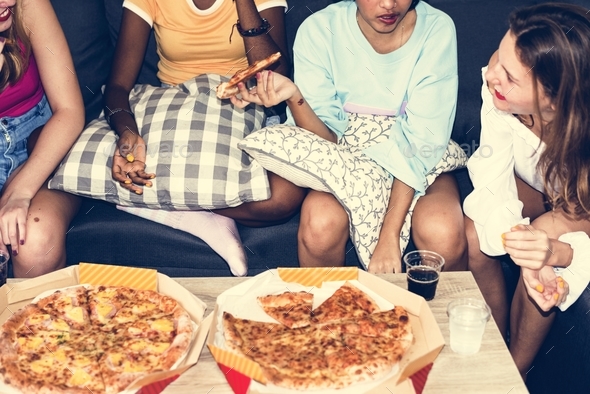 A group of diverse women sitting on the couch and eating pizza together Stock Photo by Rawpixel