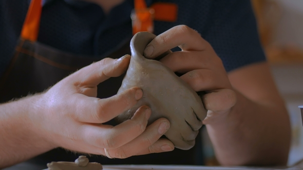 Man Making Mug in Pottery Studio Workshop