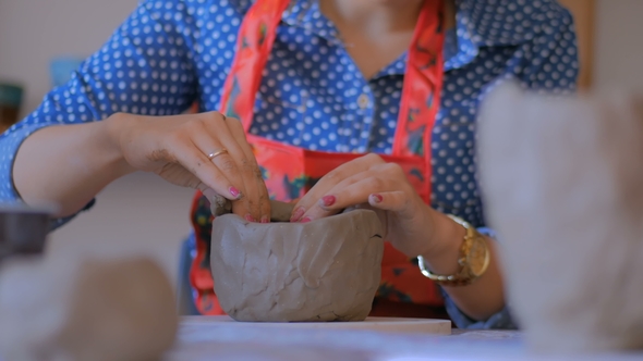 Woman Making Mug in Pottery Studio Workshop