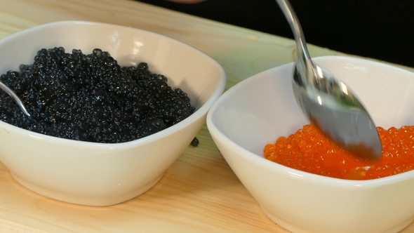Spread the Red Salmon Caviar in a Cup Next To Black Sturgeon Caviar