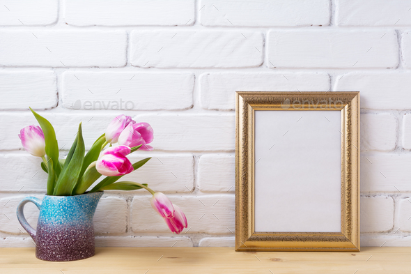 Gold decorated frame mockup with magenta pink tulips - Stock Photo - Images