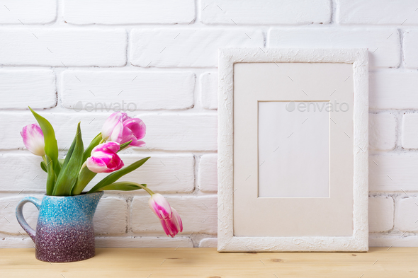 White frame mockup with pink tulip in blue pitcher - Stock Photo - Images
