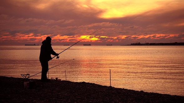 Fisherman Catch Fish, Majestic Sunset Over Water.