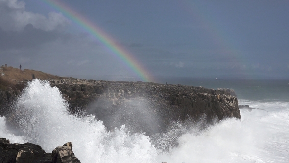Wild Waves Breaking in the Atlantic Coast with Rainbow in