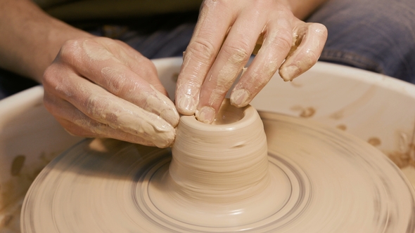 Man Works with a Potter's Wheel, Only Hands alt