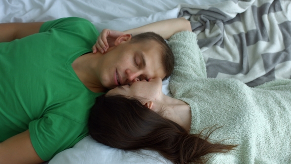 Romantic Couple Lying on the Bed Face To Face alt