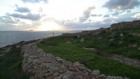 Farmer Land Protected by Stone Fence with Beautiful Sunset over Mediterranean Sea Horizon