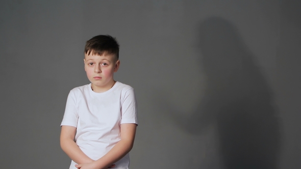 Shadow of Angry Mother Scolds Frightened Son