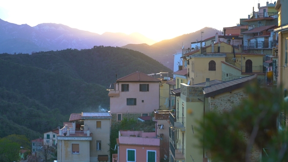 The Rising Sun Illuminates the Roofs of a Medieval Town in the Mountains.