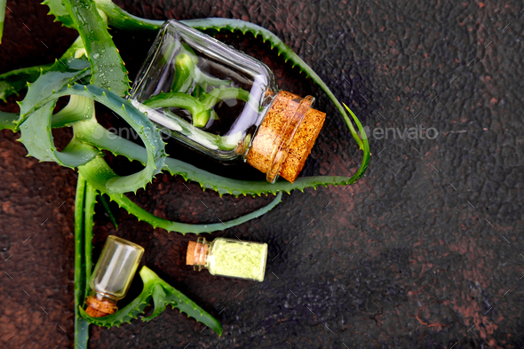 Aloe vera oil in glass bottle and towel for spa - Stock Photo - Images