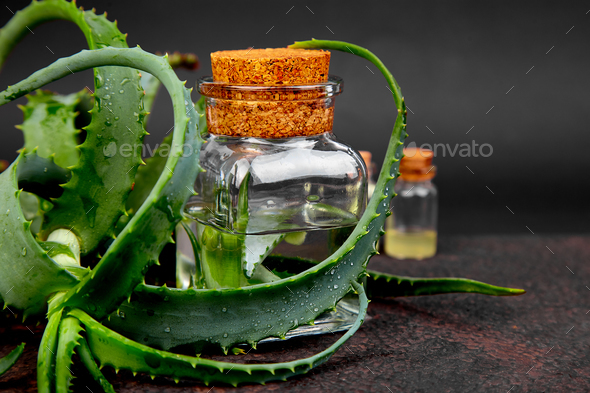 Aloe vera oil in glass bottle and towel for spa - Stock Photo - Images