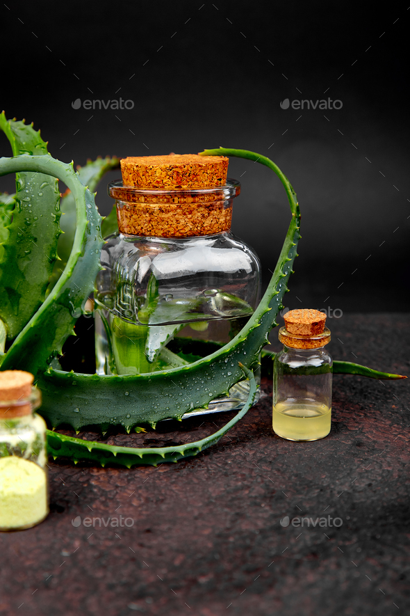 Aloe vera oil in glass bottle and towel for spa - Stock Photo - Images